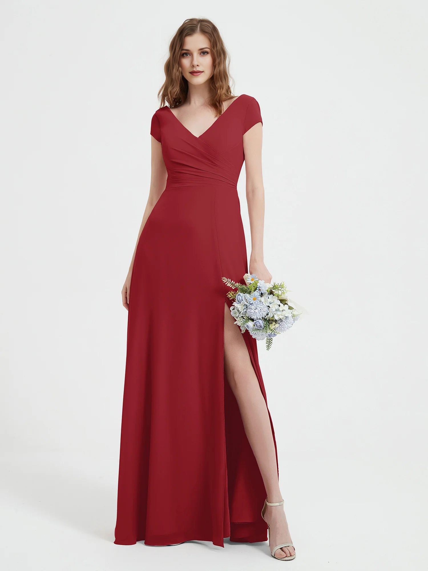 Front view of a V-neck cap sleeve bridesmaid dress with ruched bodice, side slit, and floor-length A-line skirt by VEDRESS